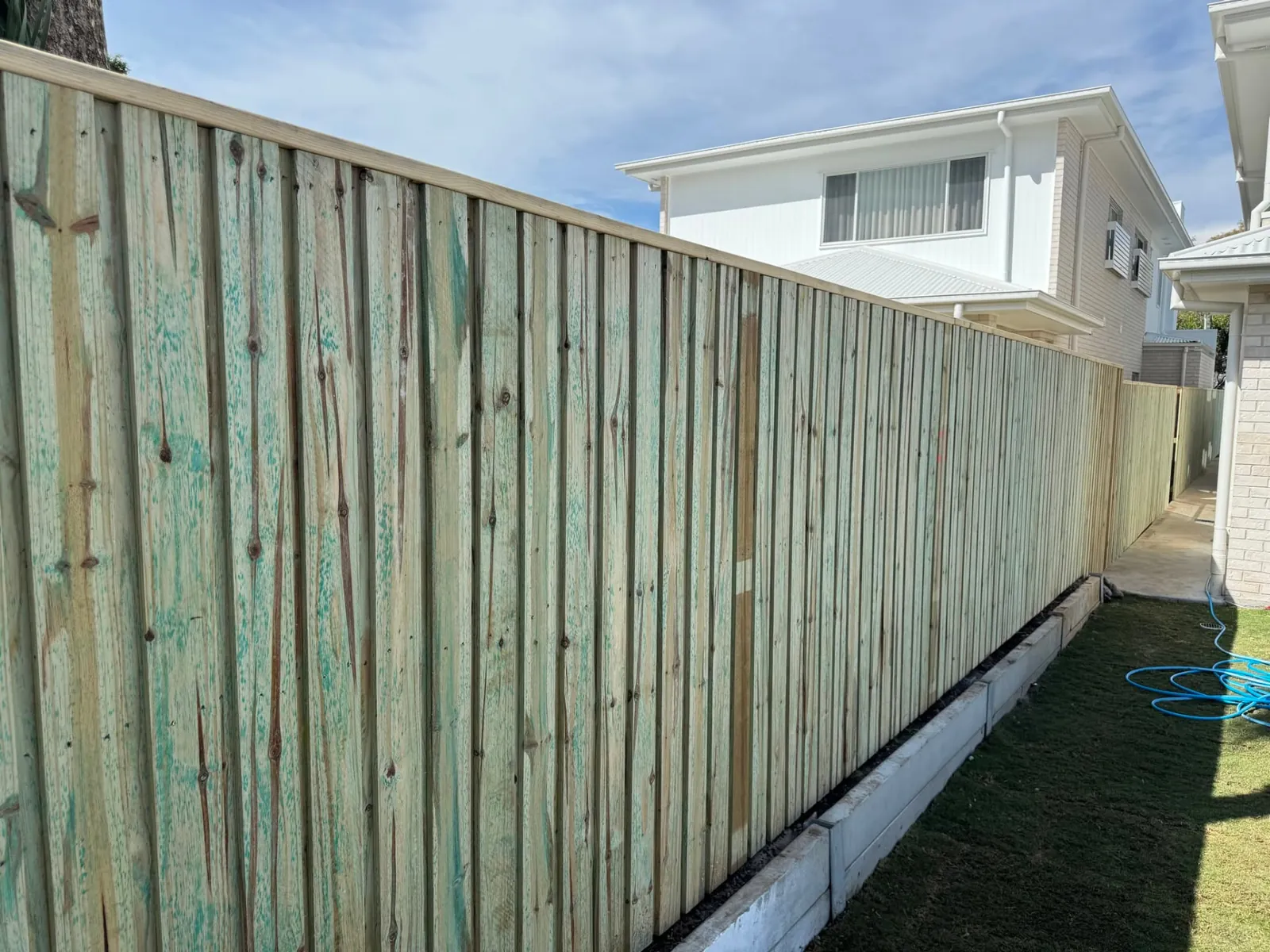 Side boundary fencing running along the edge of a Wynnum property