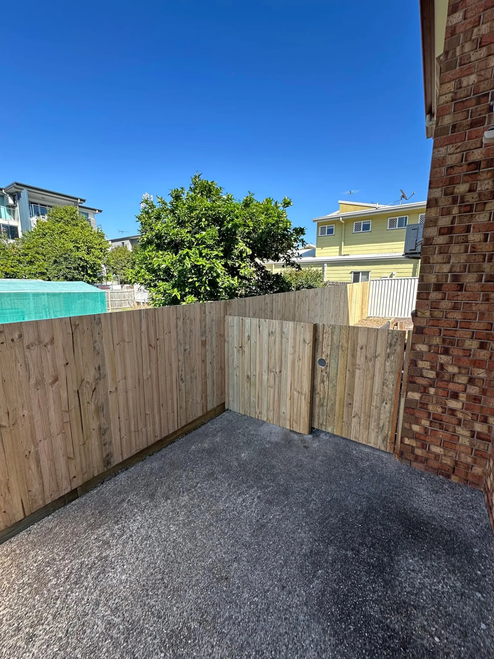 Timber boundary fence and return beside home in Morningside QLD