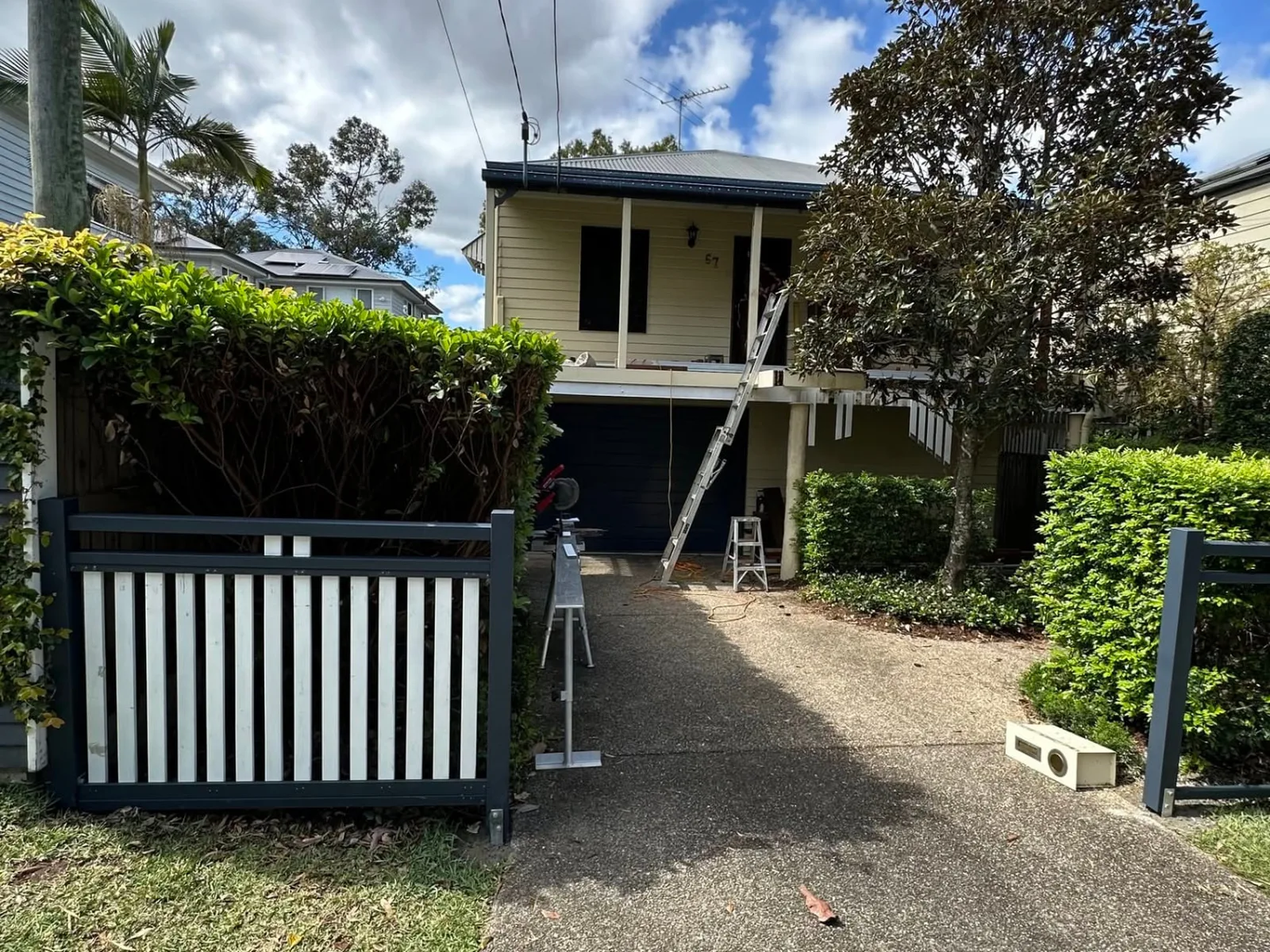 Painted timber boundary fence complementing the existing Norman Park home