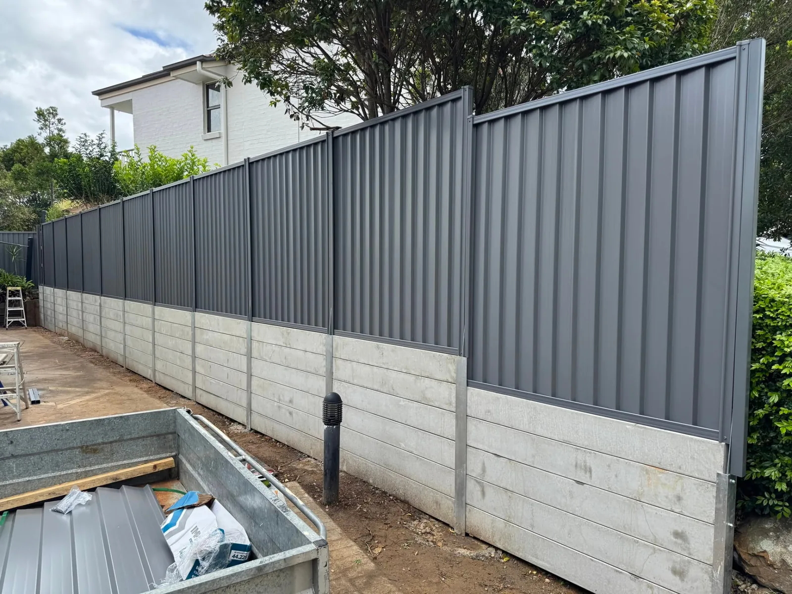 Colorbond fence on concrete sleeper retaining wall in Wynnum West